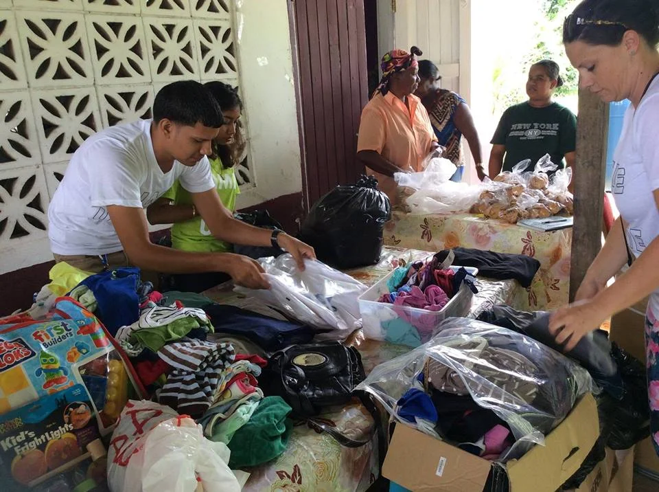 Volunteers setting up tables of donations to hand-over.