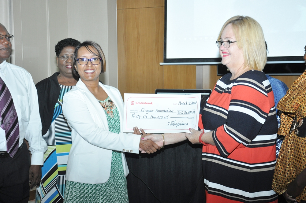 The cheque of $US36,000 being presented to Ms. Susan Isaacs, Managing Director of the Guyana Foundation by Ms. Jennifer Cipriani of Scotia Bank (left).