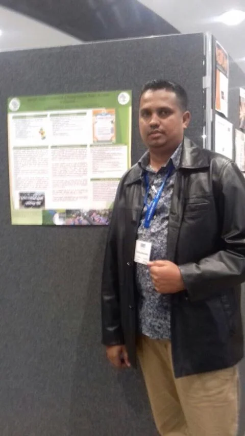 Haimraj Hamandeo, senior counselor of the Sunrise Center in session at the BABCP U.K. Conference on mental health. He is seen here standing in front of the poster board on the Guyana Foundation.