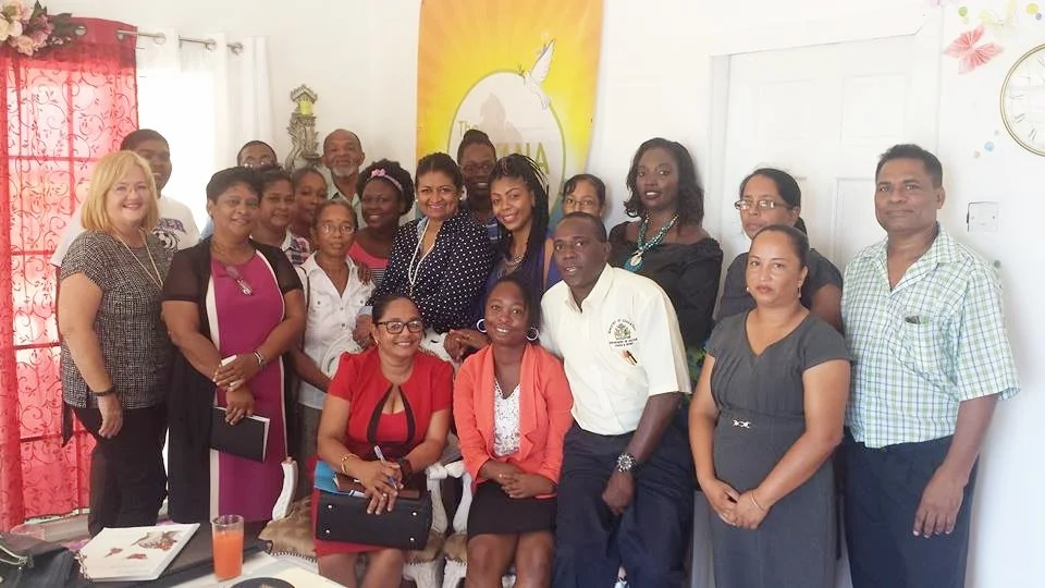 Participants of the workshop take a time out for a group picture, representatives of Social Protection at centre in chairs.