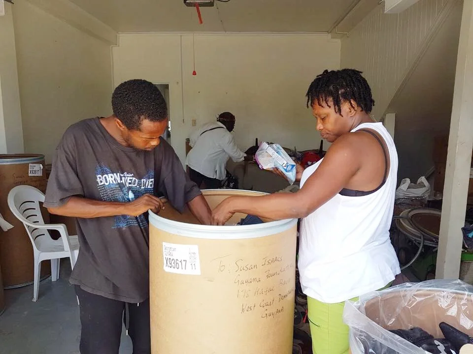 Volunteers helping to sort out the barrels donated by Ms, Fransic Yvonne Jackson.