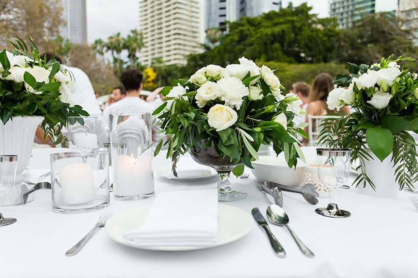 White rose, white napkins and white candles, exceptionally appropriate. 