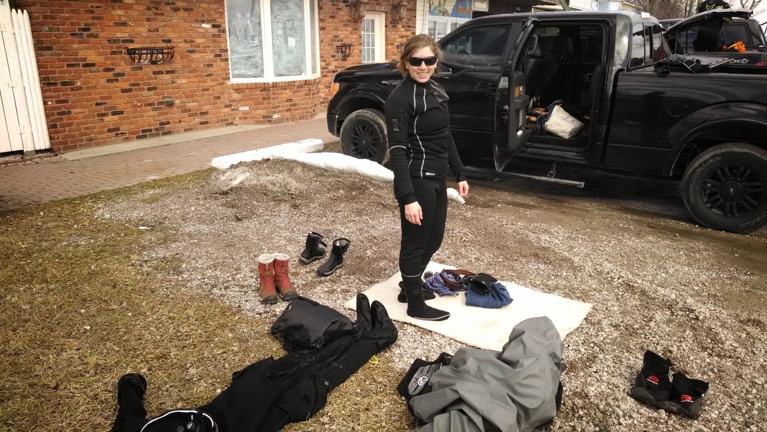 Meghan doffing her gear after a great dive of diving