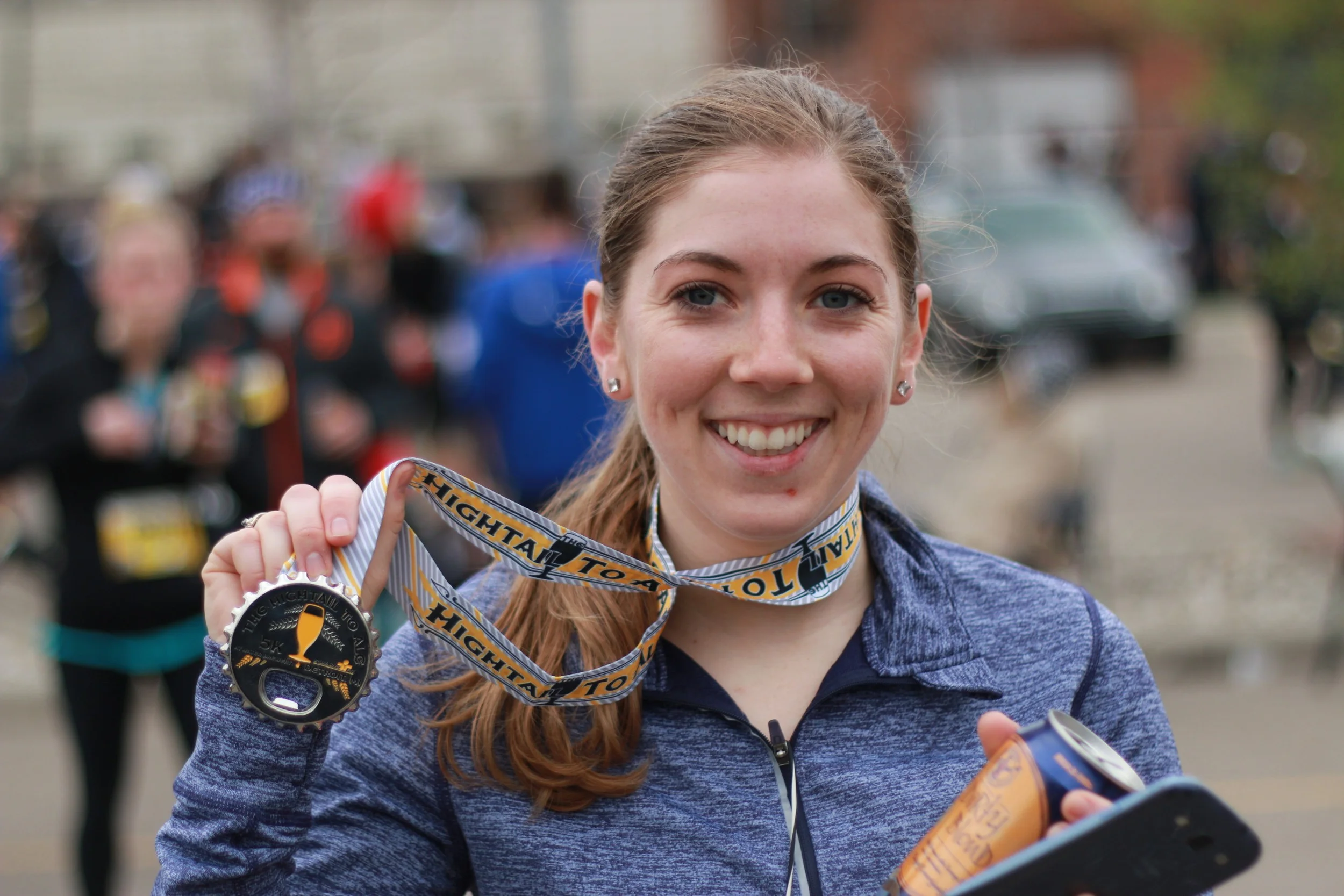 Meghan enjoying her delicious post-race Atwater Brewery Dirty Blonde beer.