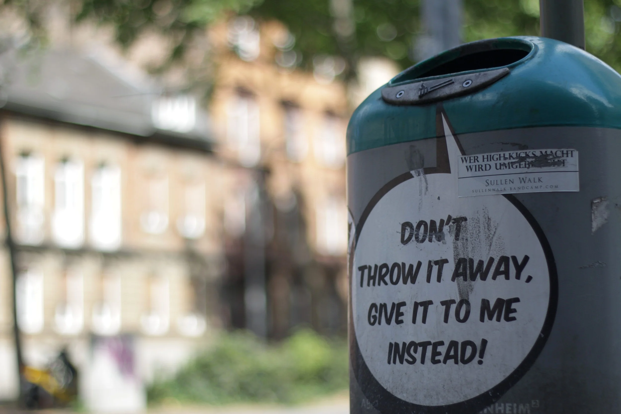 Garbage cans scattered around the city in multiple languages, including English