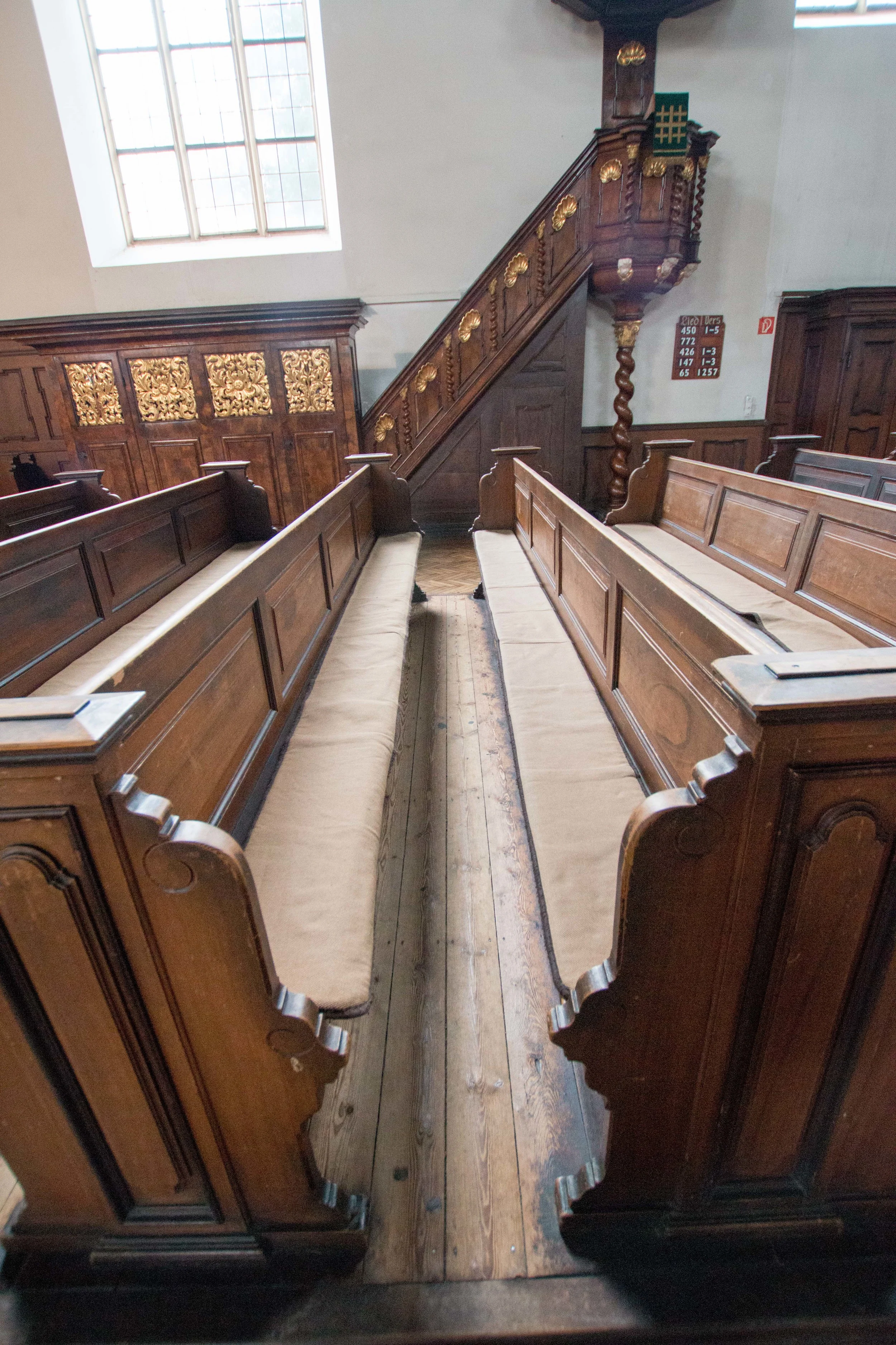 The double benches with the pulpit in the background