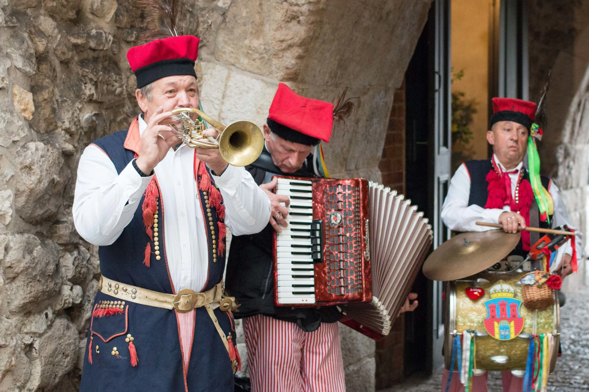 Old men dressed in traditional polish costumes that played music each day at one of the city gates