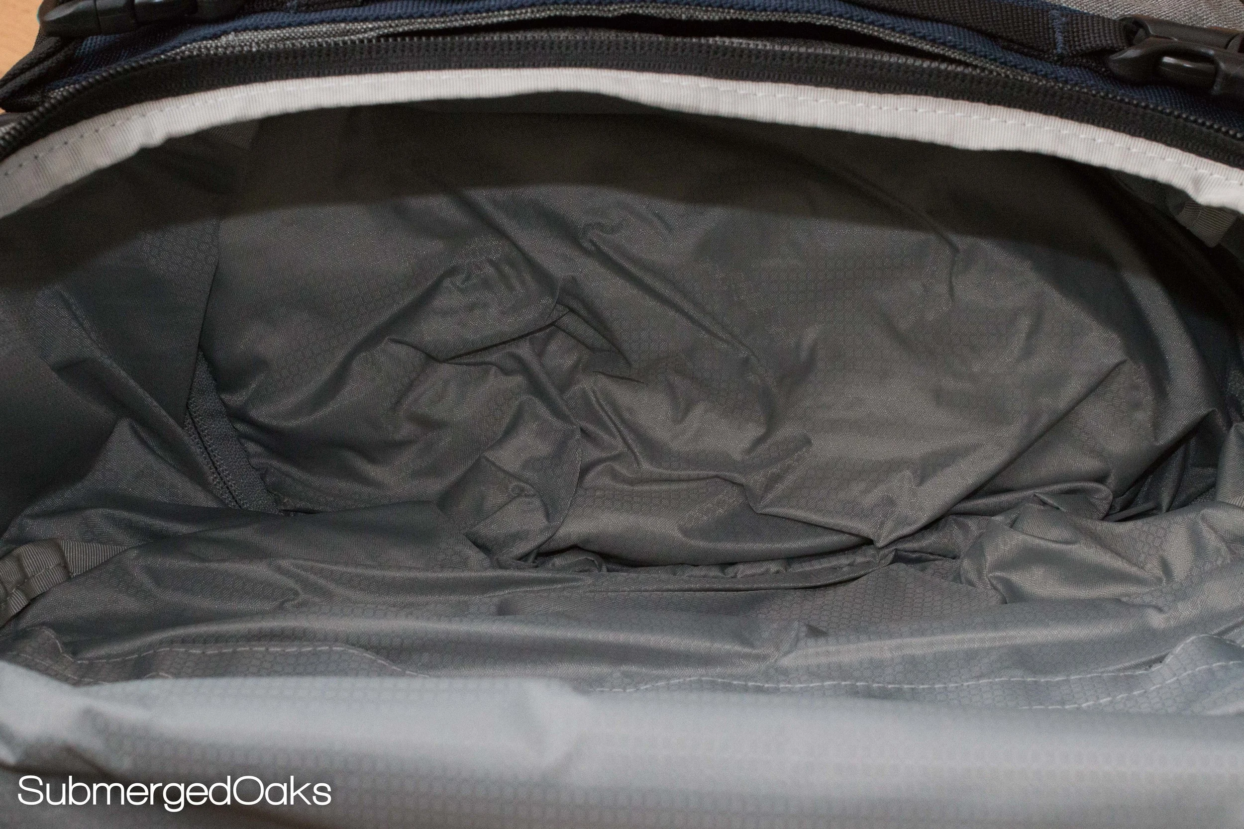 The pocket size is "unzippable" if you need more room in the main compartment.