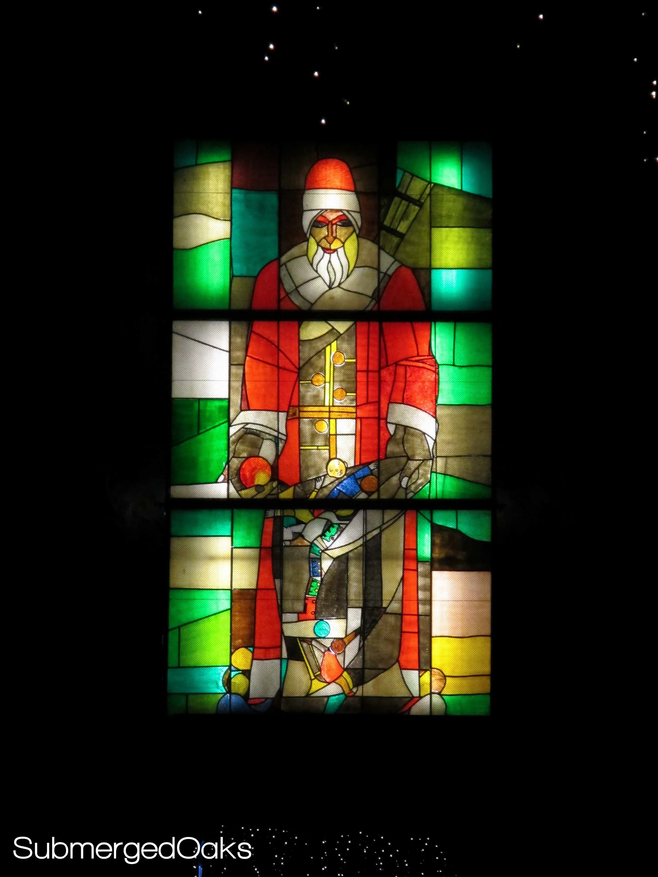 larger than life stained glass window of St. Nicholas on the city gate