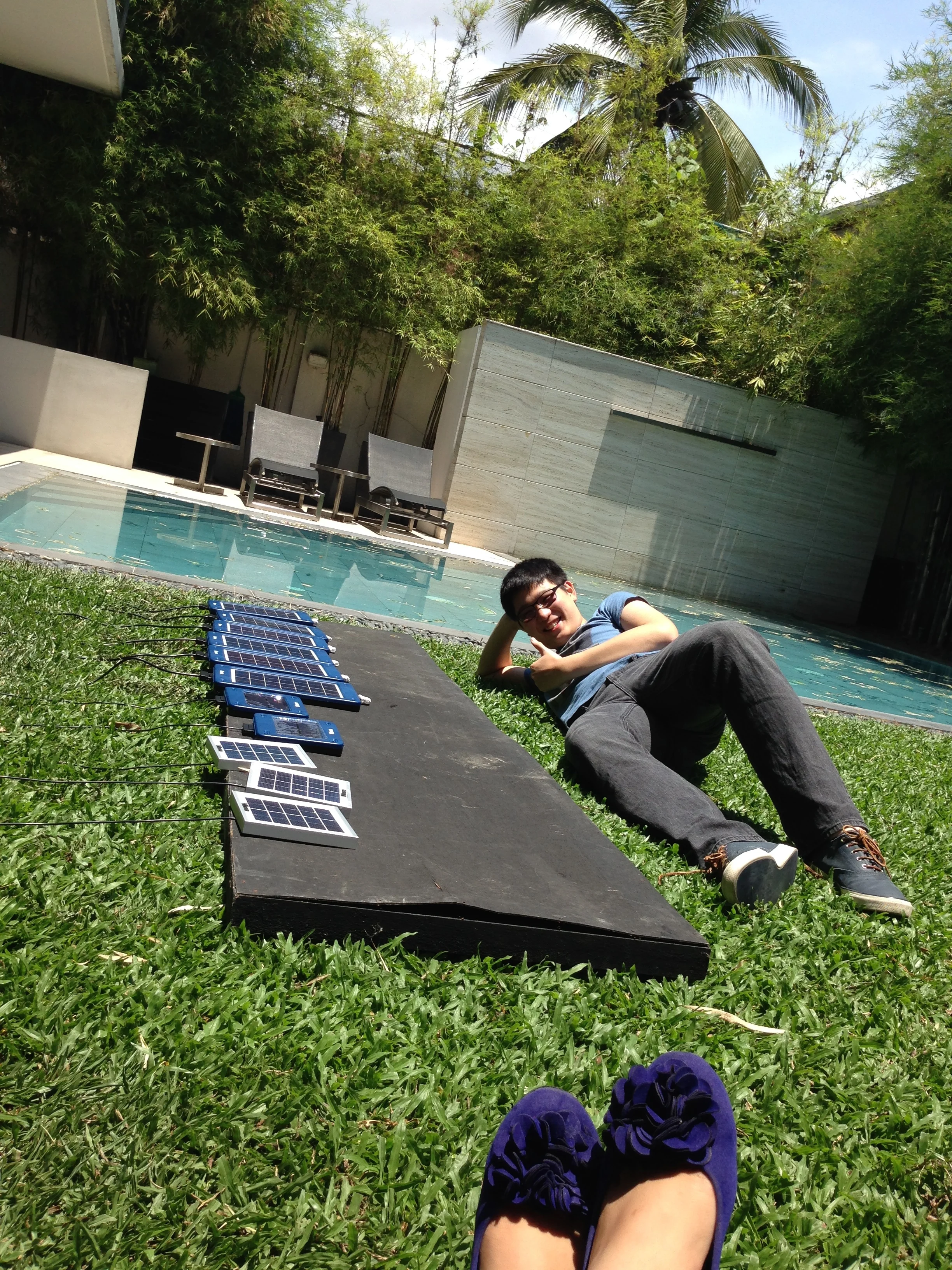 HSSi Intern Matthew Yap with the company's solar panels.