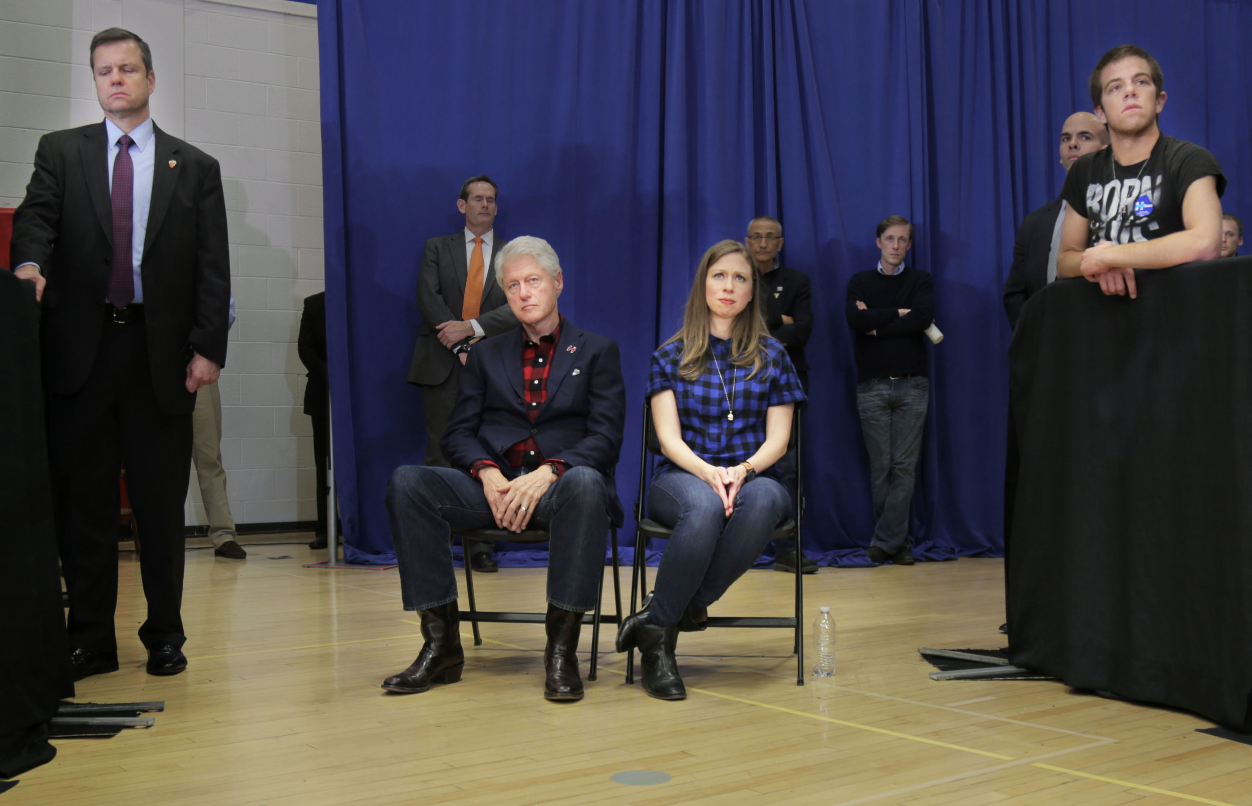  Former President Bill Clinton and daughter Chelsea Clinton listen while Secretary of State Hillary Clinton gives a speech in Cedar Rapids, Iowa, days before the Iowa Caucus 