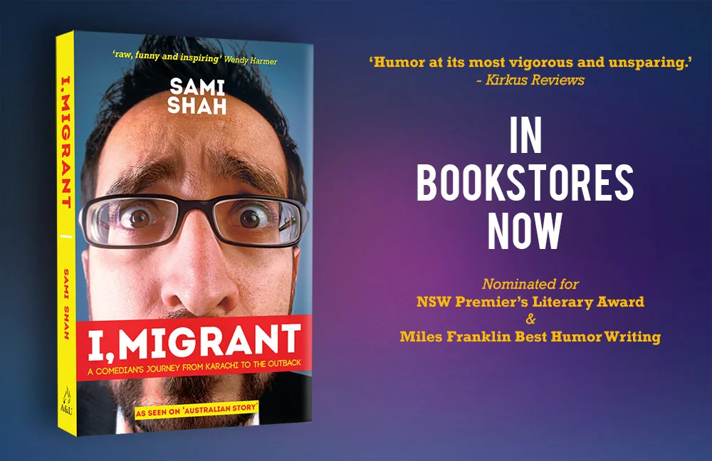 Book cover titled 'I, Migrant' by Sami Shah featuring a close-up photo of a man with glasses, wide eyes, and dark hair. Text on the right indicates the book is now in bookstores, nominated for awards, with reviews and quotes about its humor.