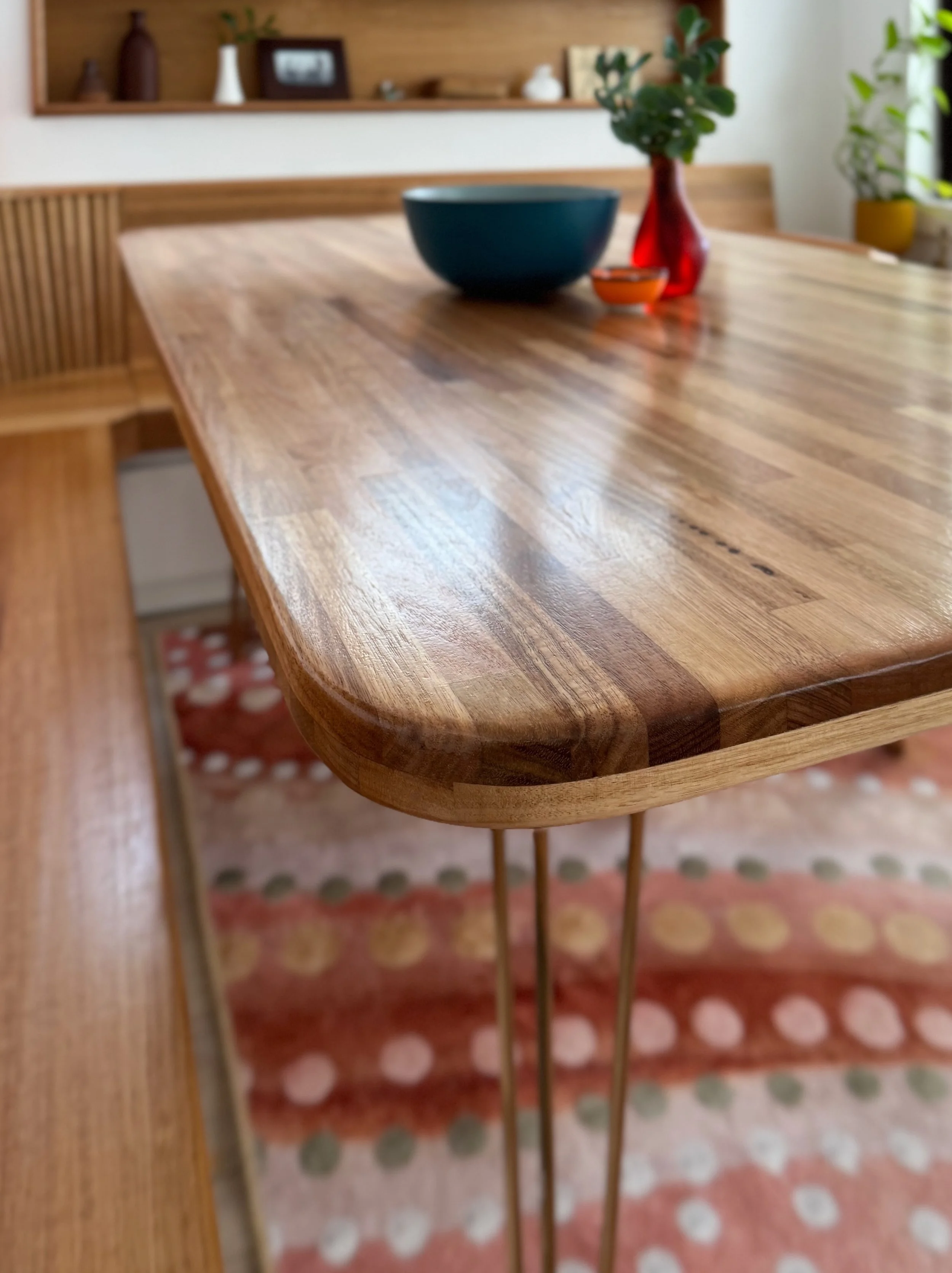 My $400 dining table top is made from hardwood panels layered to create a solid top, with corners shaped to nestle against the built-in seating. It&rsquo;s sealed in a marine varnish that results in a lovely tactile finish. Time to replace those hair