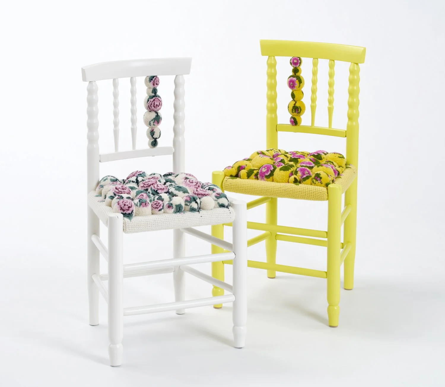 two chairs with pompon upholstery