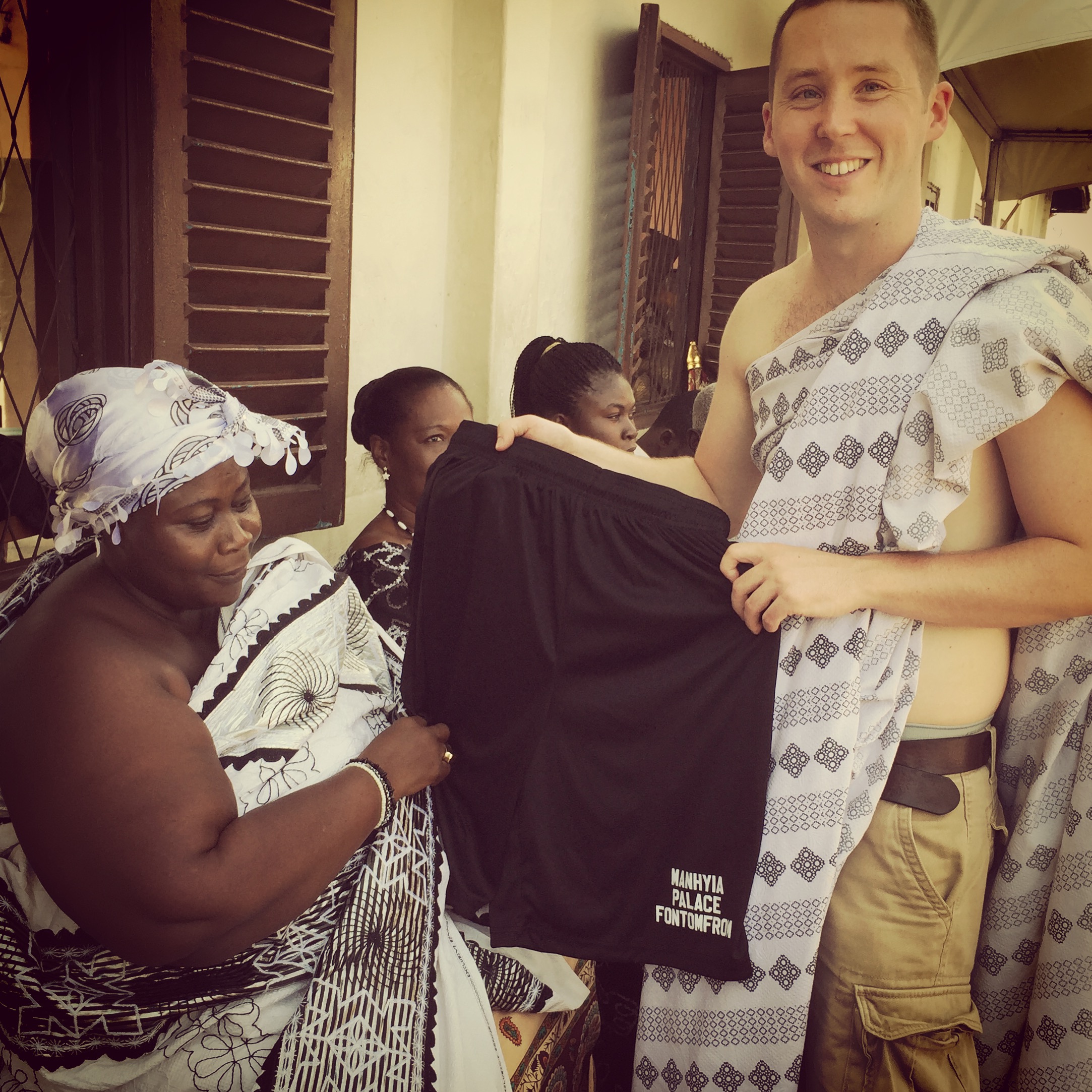 Presenting a gift to the Queen Mother of the Ashanti King's Fontomfrom drum ensemble. 