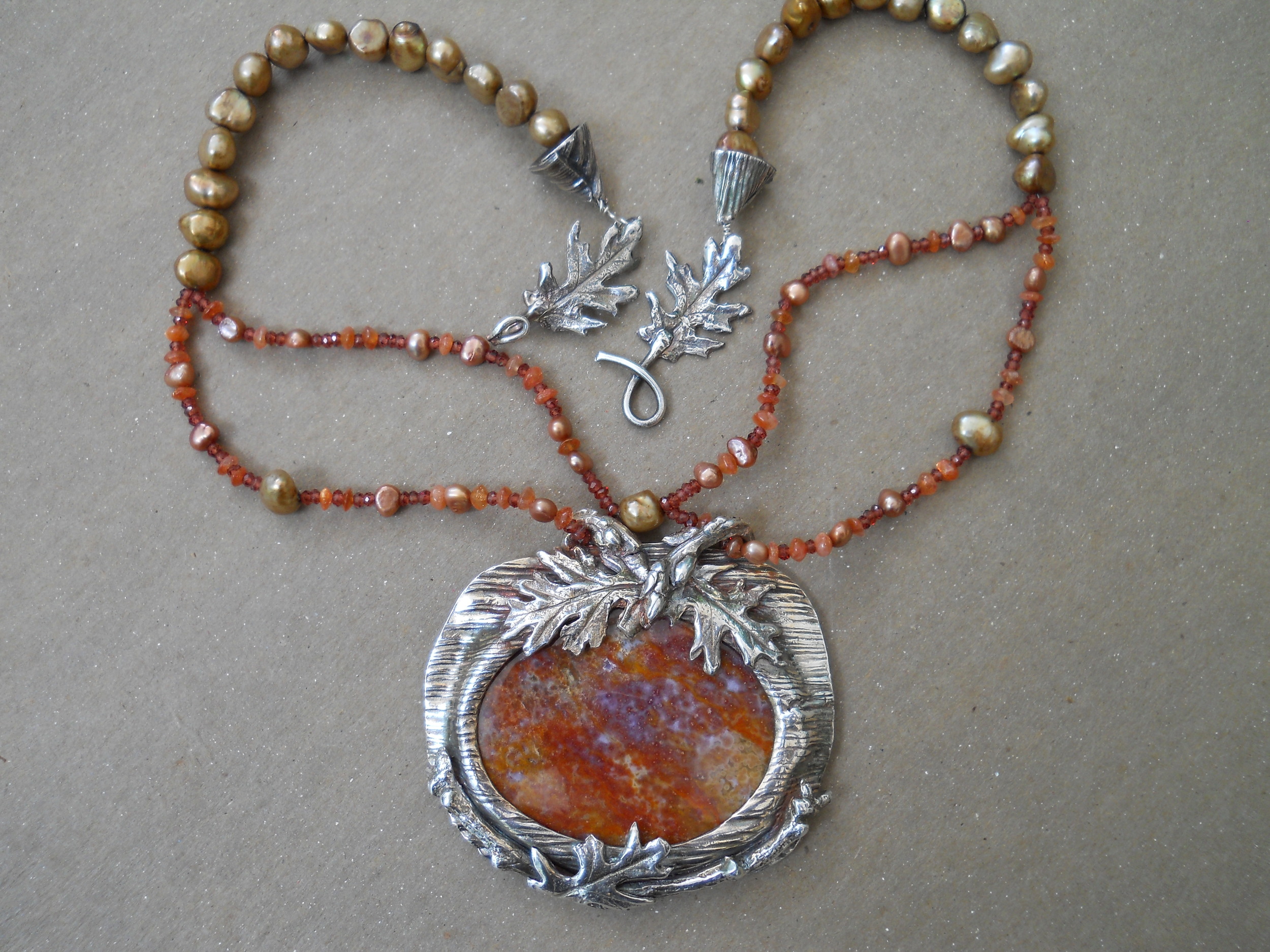 fine silver,petrified wood, pearls, sun stone and garnets