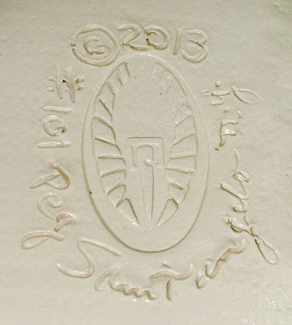 The logo is on the bottom/back of each piece. It is a pictogram of the name Peg Santangelo. The center shape is a tent peg for "Peg". The square halo is the symbol for a living saint for "Sant." The angel wings are for "angelo" or angel. Hence, Peg Santangelo. The Altar Bowls and Egg Shaped Wall Hangings are all hand-signed, dated and numbered. Each piece is a unique one-of-a-kind art piece so no two are alike. They are made by hand and not machine d.