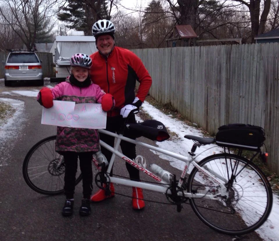 Zoe and Dad in February 2014, celebrating her 1000 miles of cycling while aged 9.
