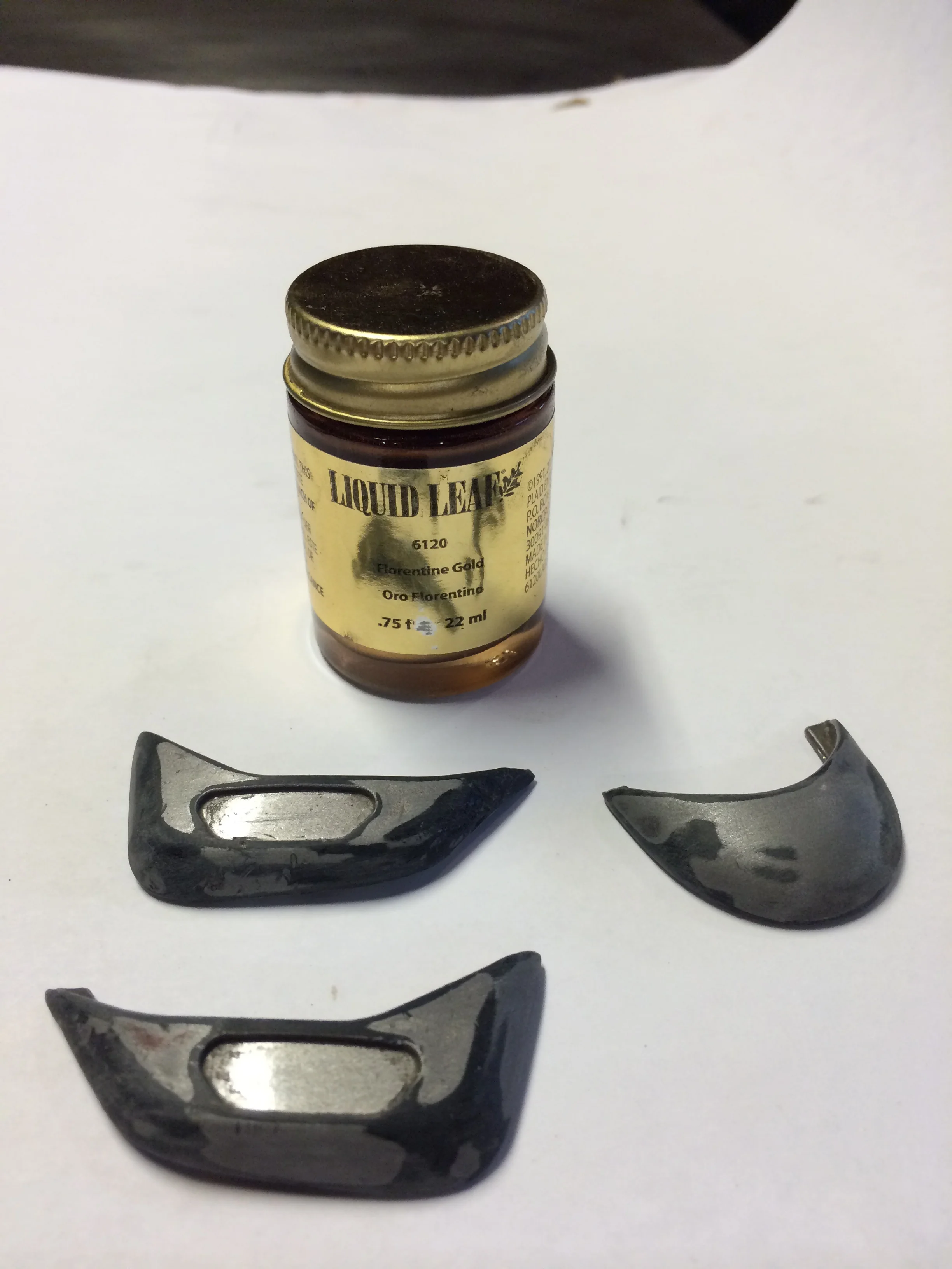 These little tabs came right off. Actually they didn't, I had to cut the melted plastic from underneath. When they injection molded these, they made little pins that went into holes on the saddle and melted them in. The piece was made like a clip too.