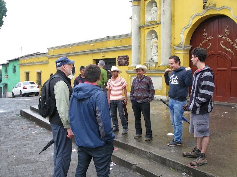 One of our coffee farmers, Don Filiberto (in the cowboy hat), and two of his sons, meet a group in the main plaza of San Miguel Escobar.