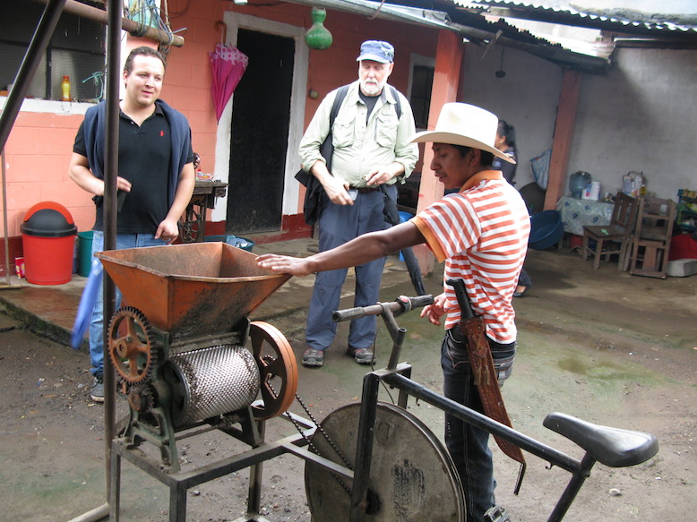 Carlos shows off the pulpador, which removes the fleshy outer layer of the coffee fruits and separates out the bean.