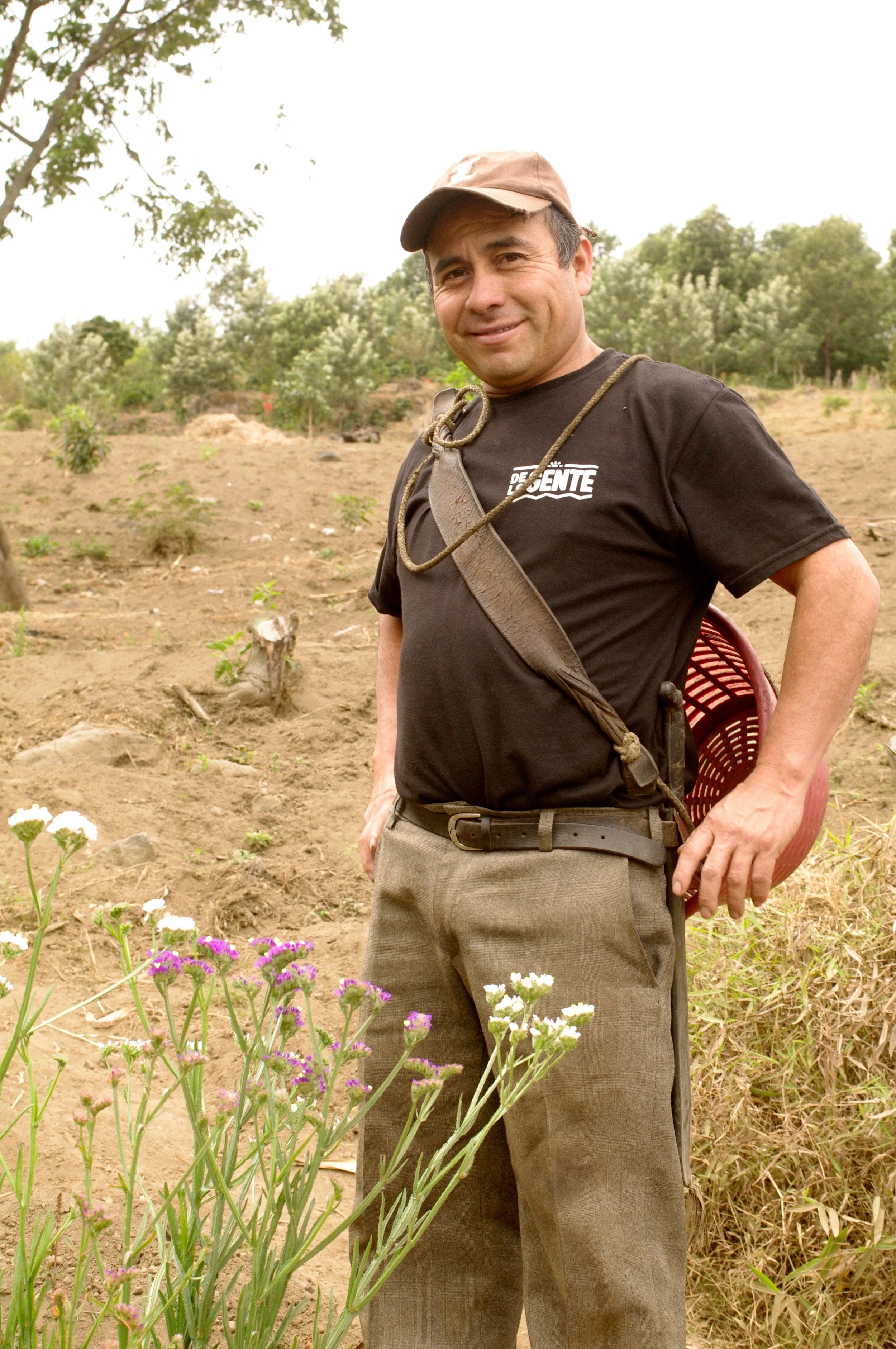 Froilan with the flowers that opened the opportunity of working with coffee.