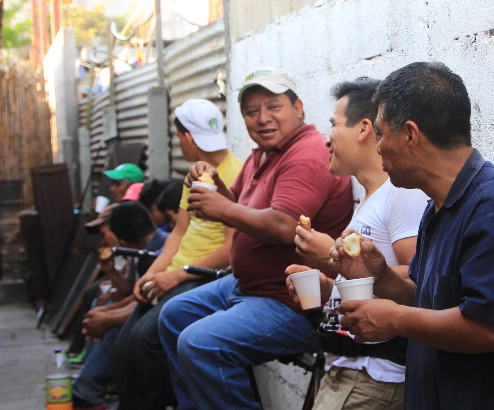 Angel (in white) laughing with Andrés (in maroon) after loading all the coffee into the container for export 2016