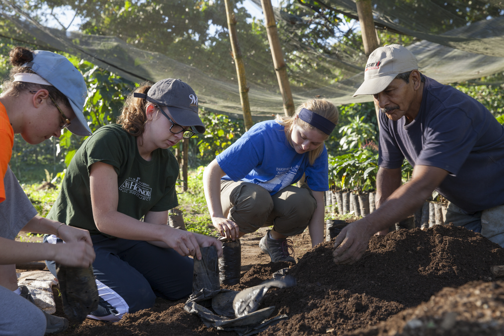 Student's working with Mincho to plant new seedlings in the Santa Anita plant nursery.