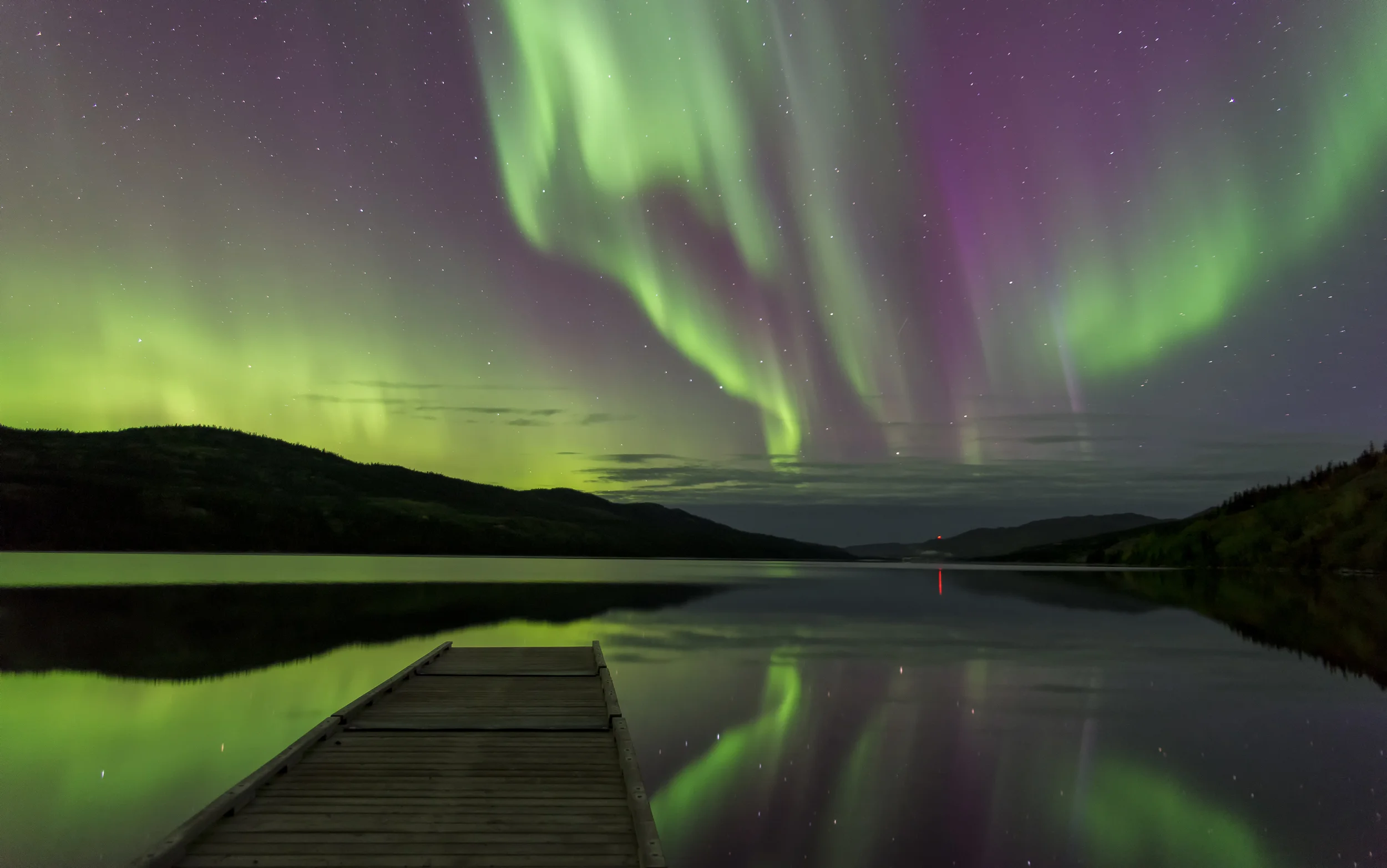 How do the Northern Lights occur and where can I photograph them?