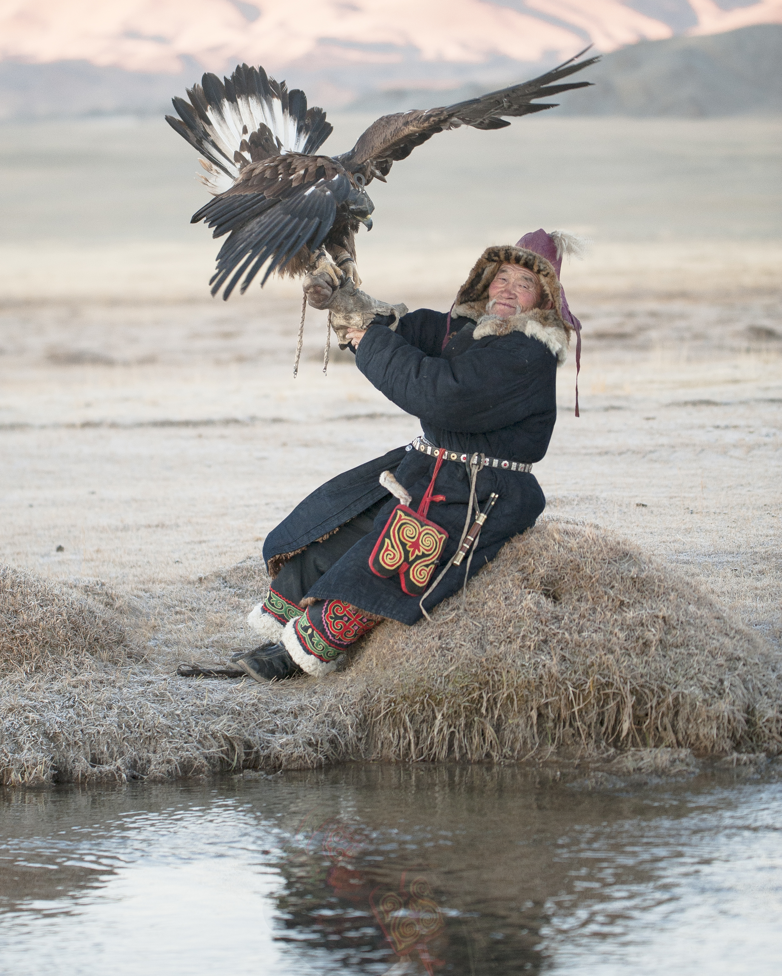 elderly kazakh eagle hunter posing with golden eagle 2.jpg