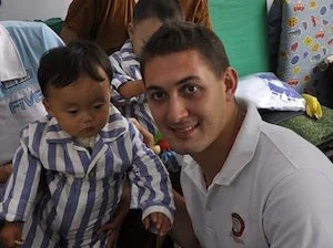 Shanghai Rotaract club president Robert Halasz visits children after the successful rebuild of a paediatric surgery unit.