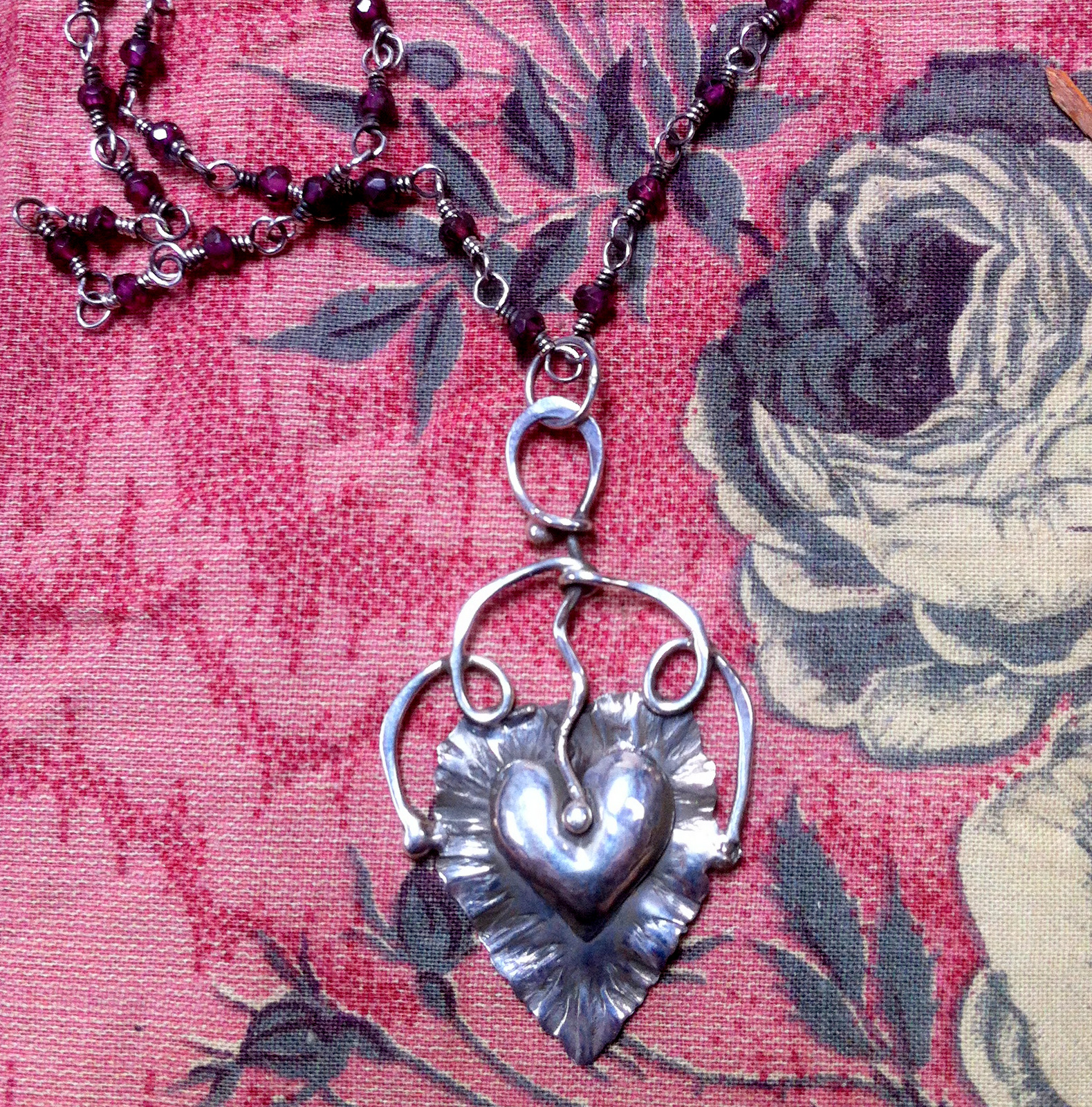 Silver heart on a silver leaf