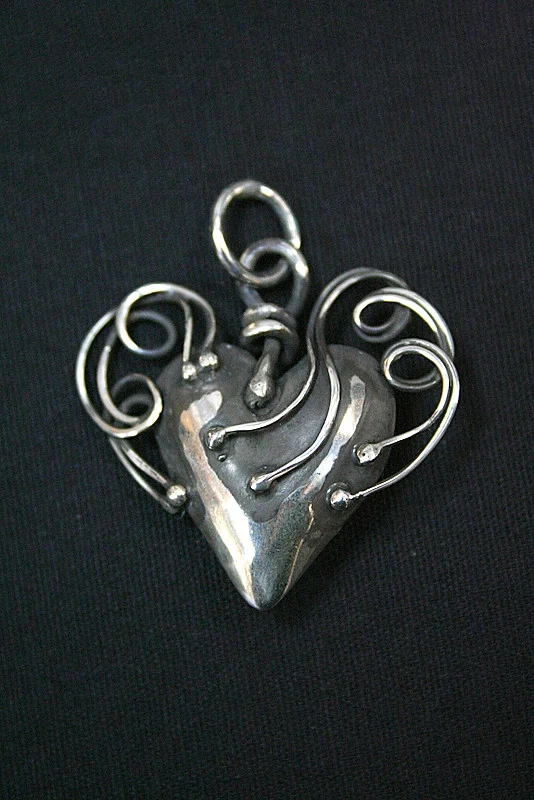 Silver Heart with twisted arms of strength and security
