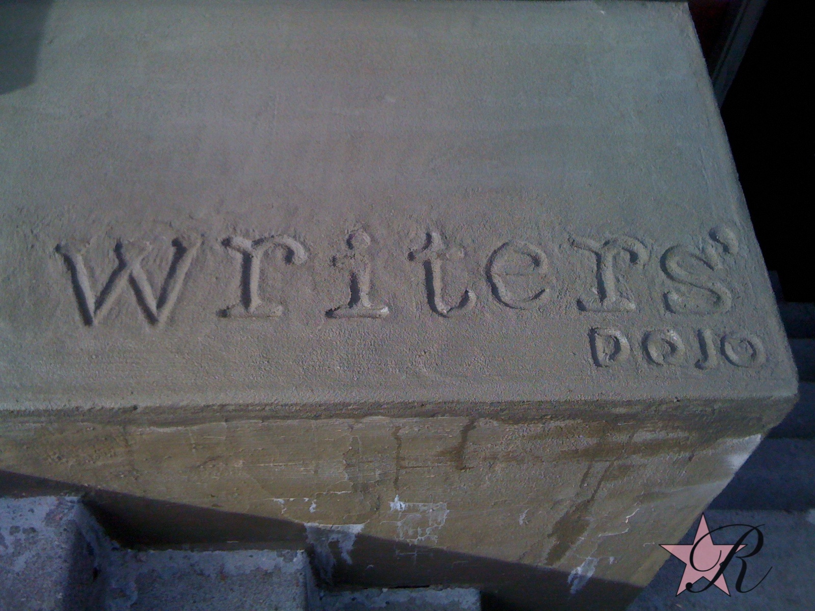 While doing concrete repair work at the Writers' Dojo, an oasis for writers to go for quiet space to work in, Rockstar Remodel hand drew the business name into the concrete so it would be easier to locate for patrons. 