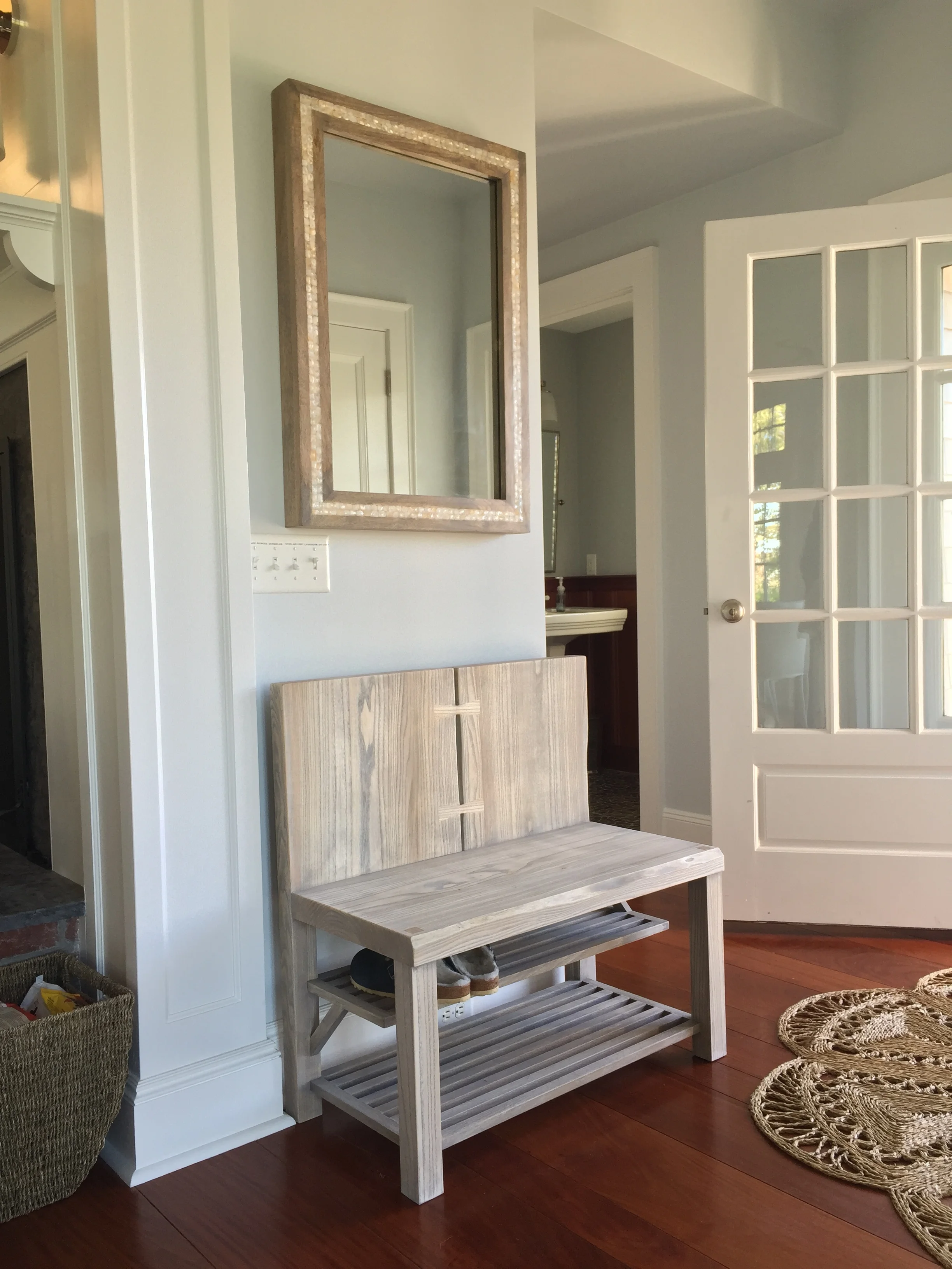 American Elm live edge slab. White Oak slatted shelves. Custom finish to match mirror.