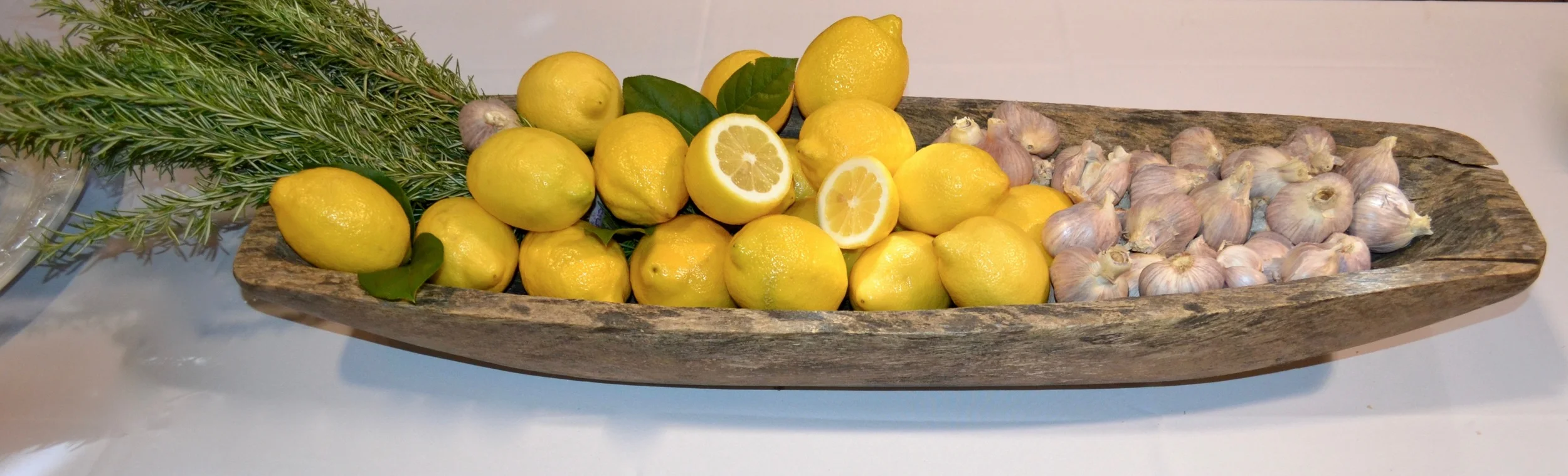 rosemary, lemons & garlic in an antique bread bowl for the buffet table