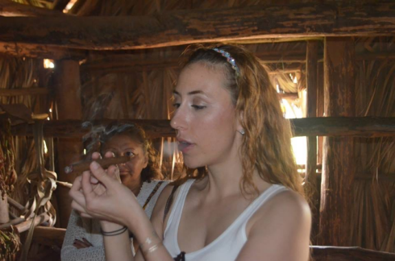 Smoking a freshly rolled cigar at a tobacco plantation in Vinales, Cuba