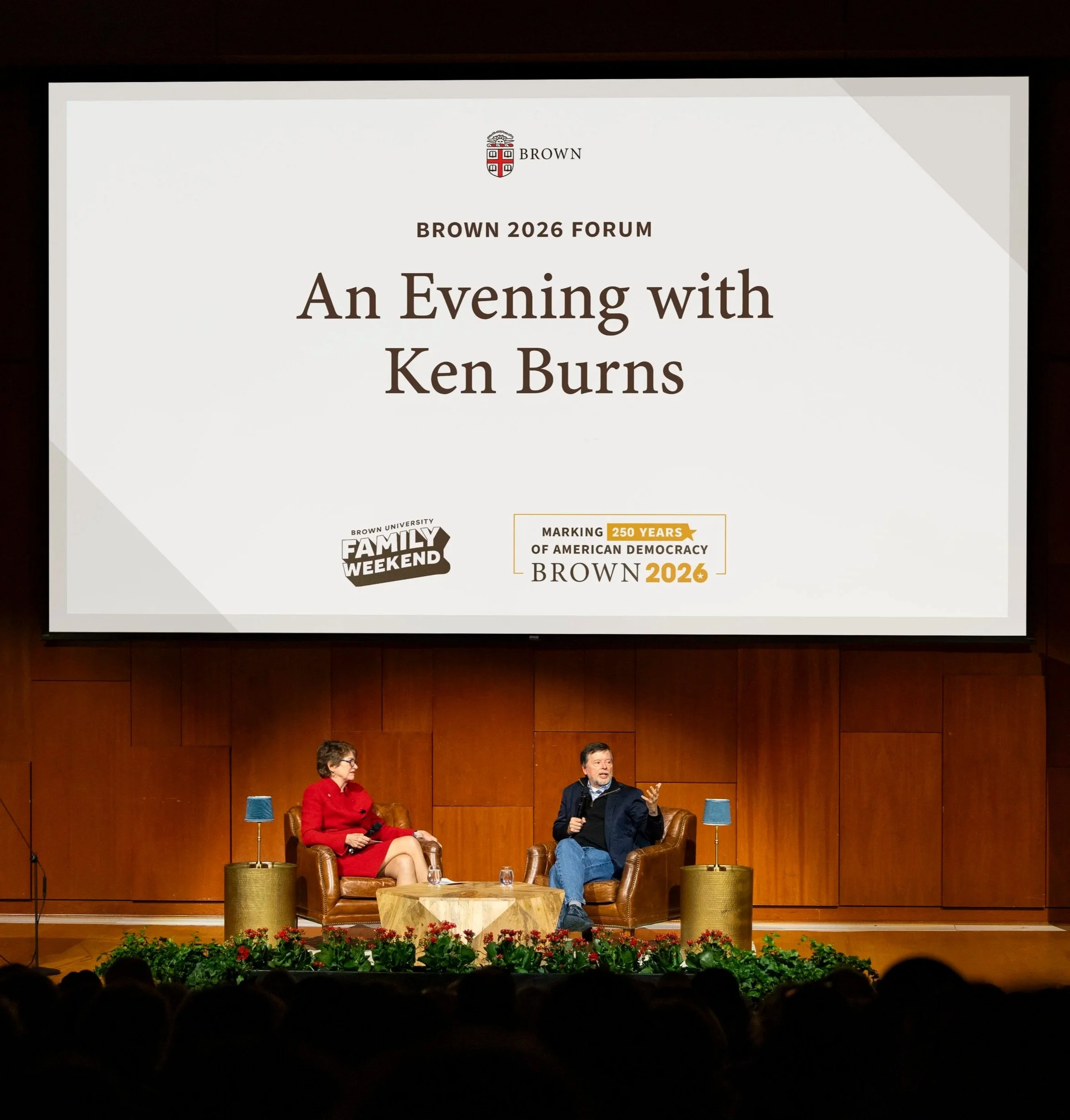 Ken Burns and Christina Paxson speak on stage during an event at Brown University