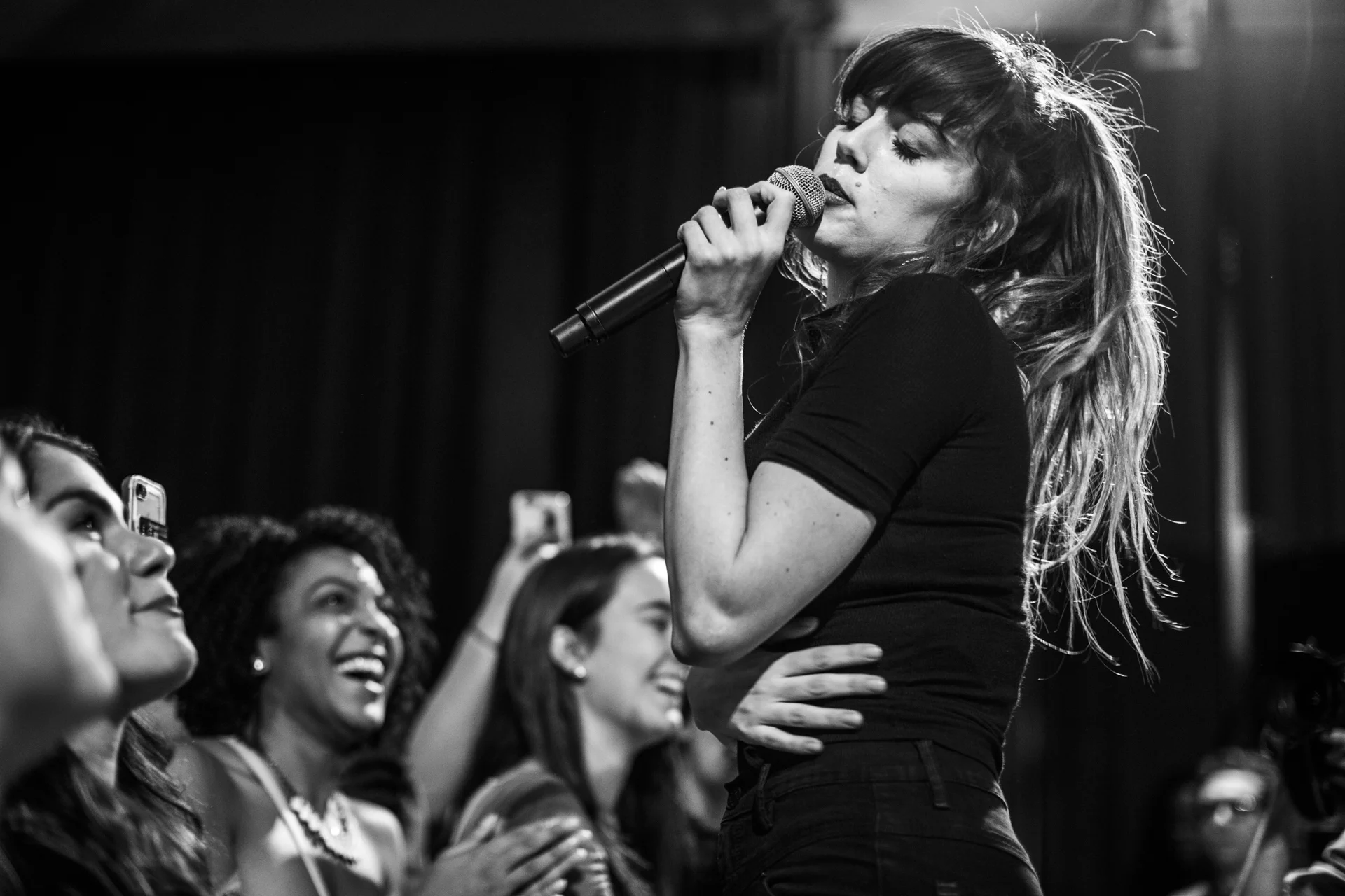  Ryn Weaver, a singer and song writer,&nbsp;sings a song with the crowd in the Alumni Hall in the HUB-Robeson Center on Nov. 4, 2016. 