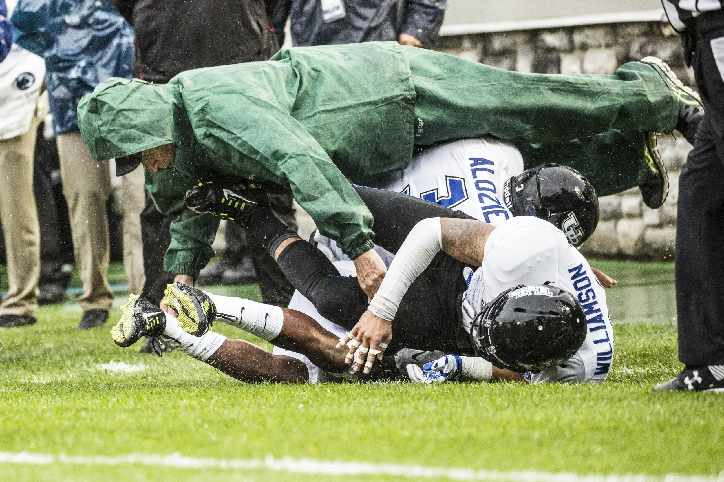  Buffalo Bulls' Linebacker Okezie Alozie (3) and Safety Ryan Williamson (26) &nbsp;knock over a bystander on the sideline on Sept. 12, 2015. 