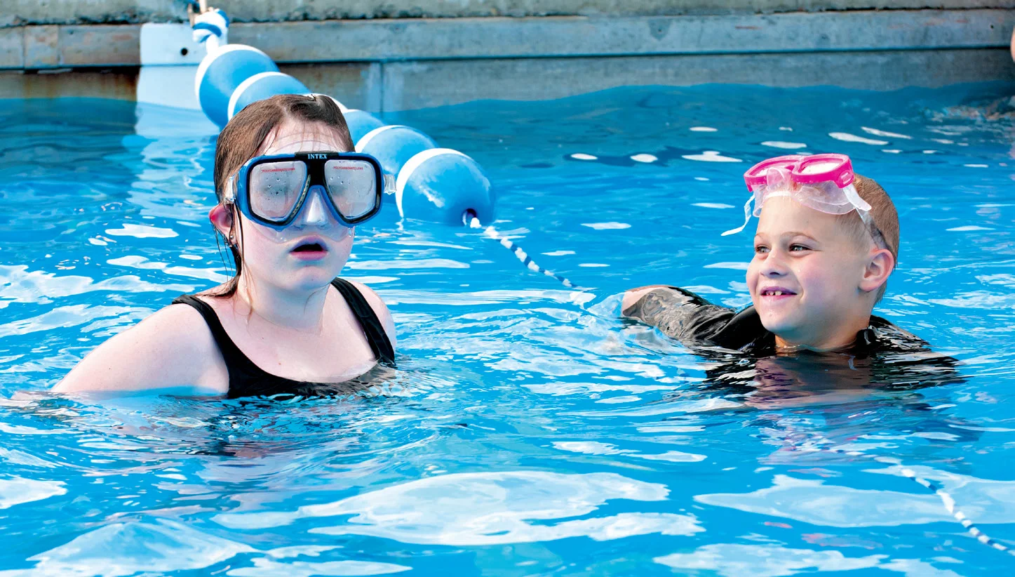 While vacationing at the resort, 14-year-old Brooklynn Fertig, left, plays in the swimming pool with her 9-year-old cousin, Hunter Russell.