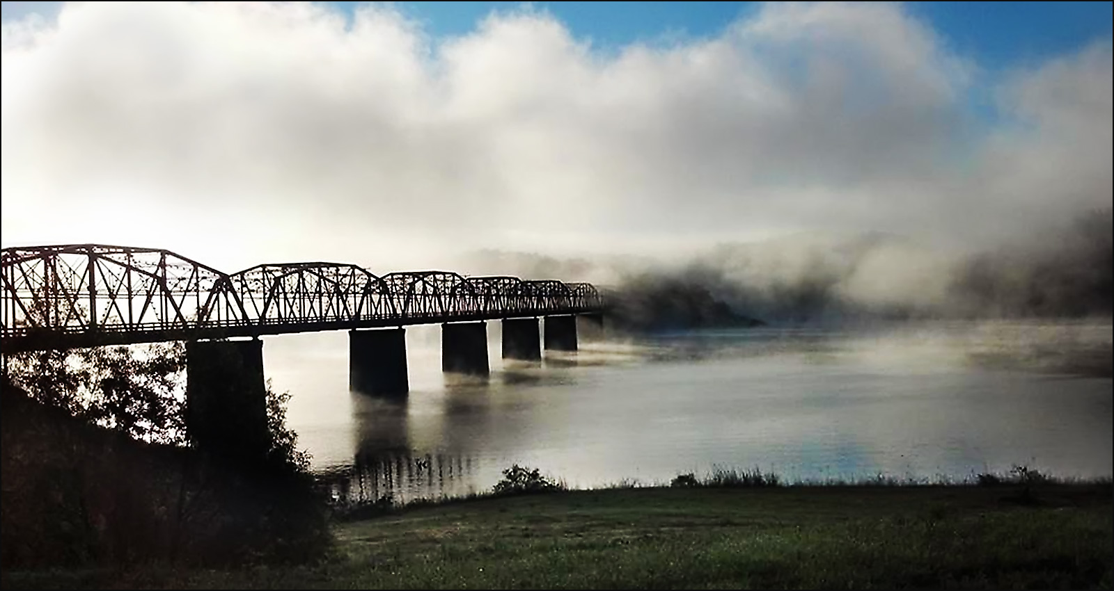 Mist rises from Bull Shoals Lake at Theodosia Bridge, viewed from Theodosia Marina-Resort.