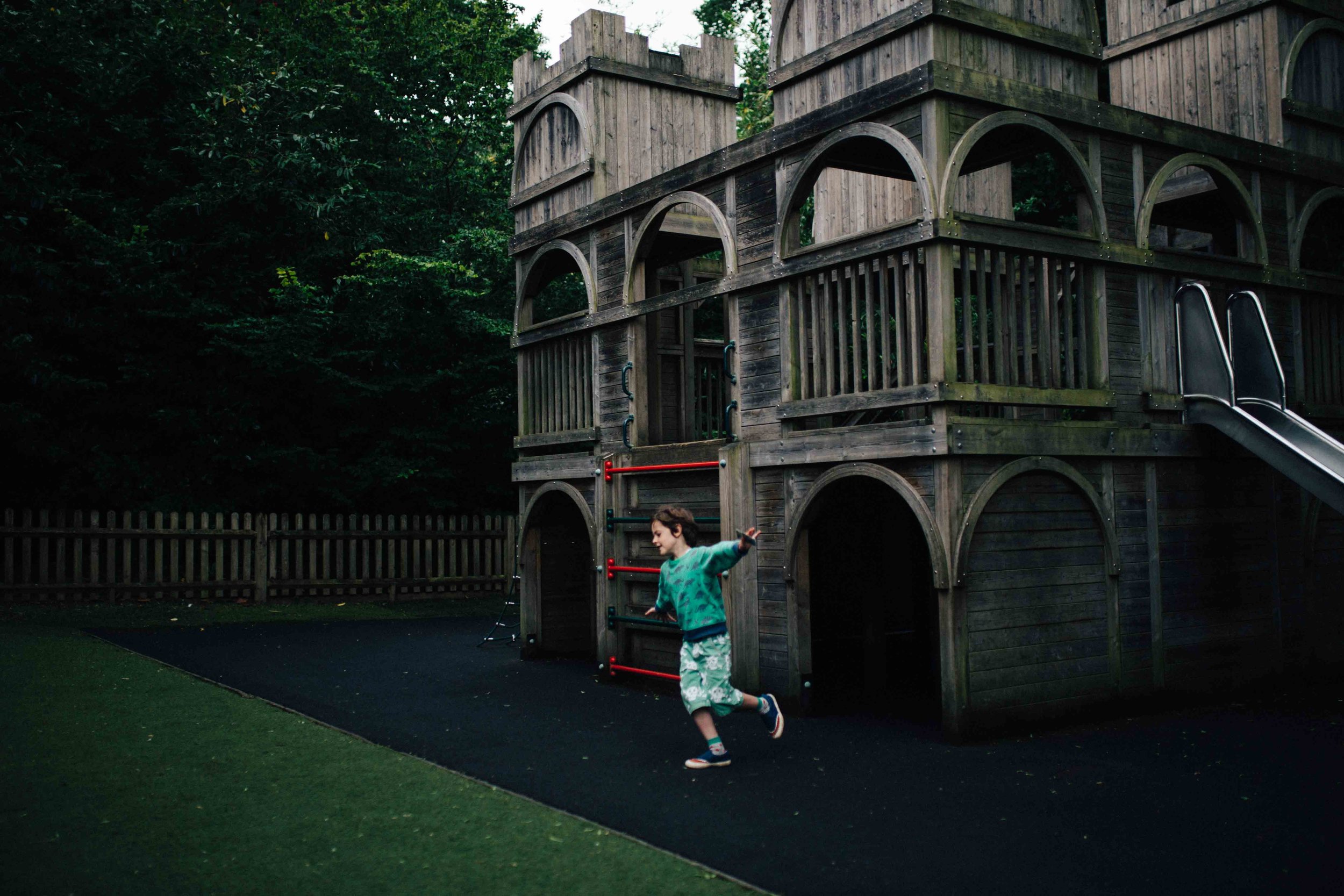 Boy doing the airplane in Claremont Landscape Garden's children's play area