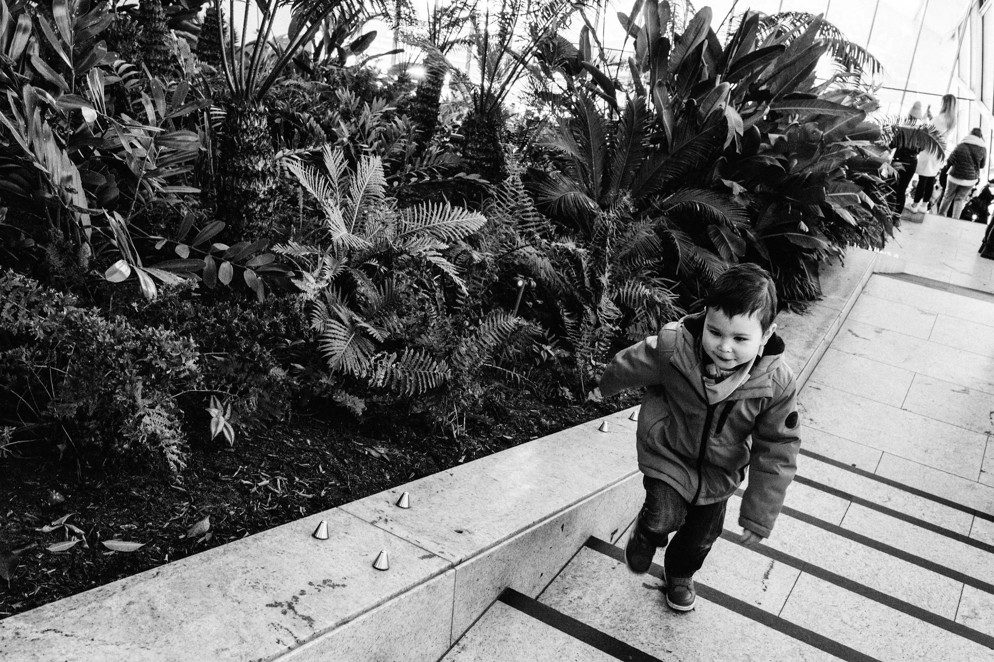 Child climbing up stairs at Skygarden during London photoshoot