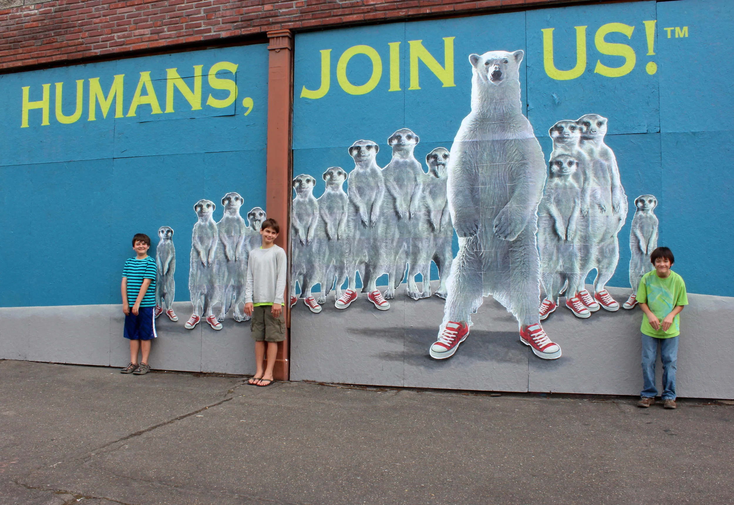 Some meerkat fans stop by the mural.