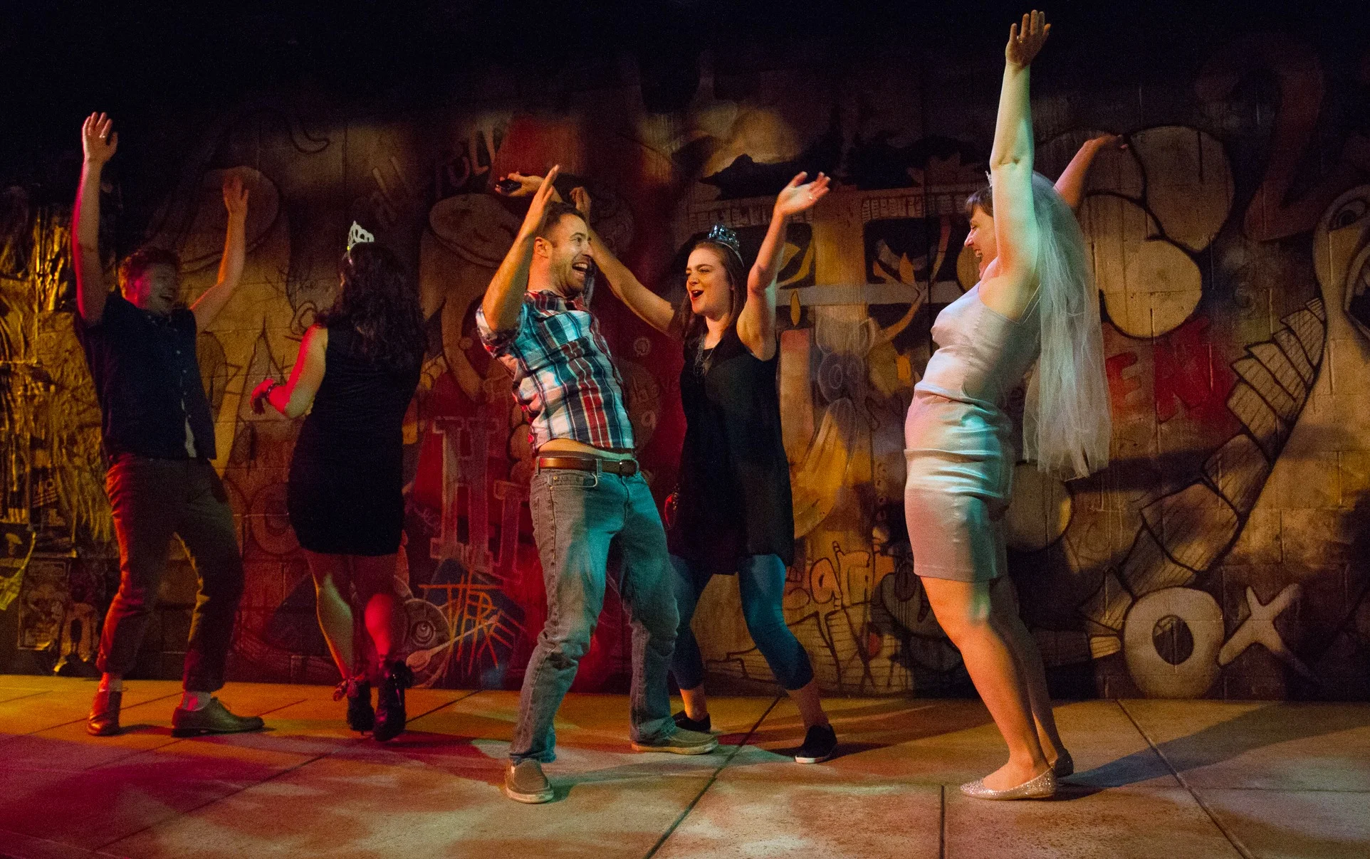 The whole cast in front of The Drunken City's backdrop.