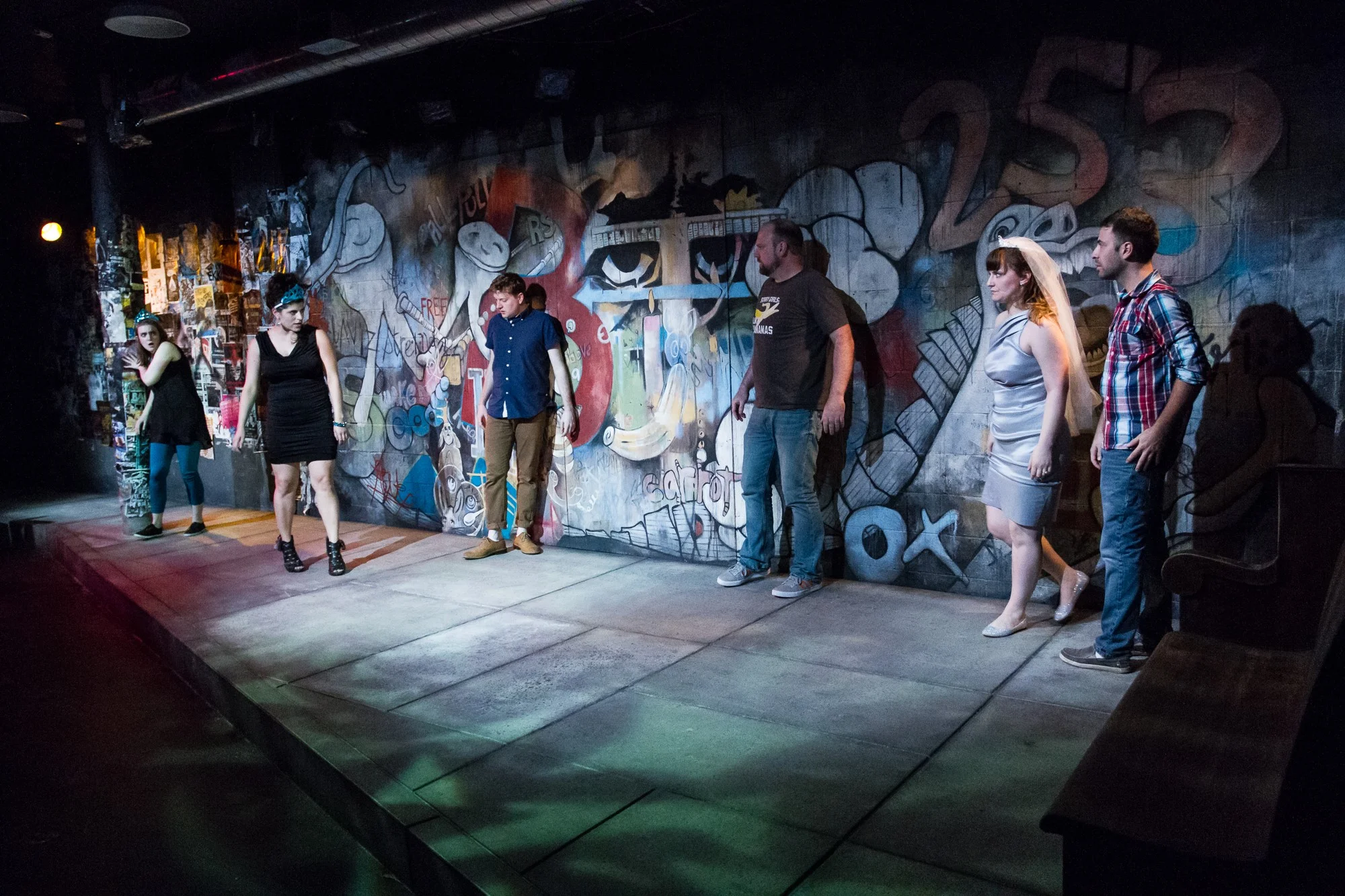 The whole The Drunken City cast in blue light.