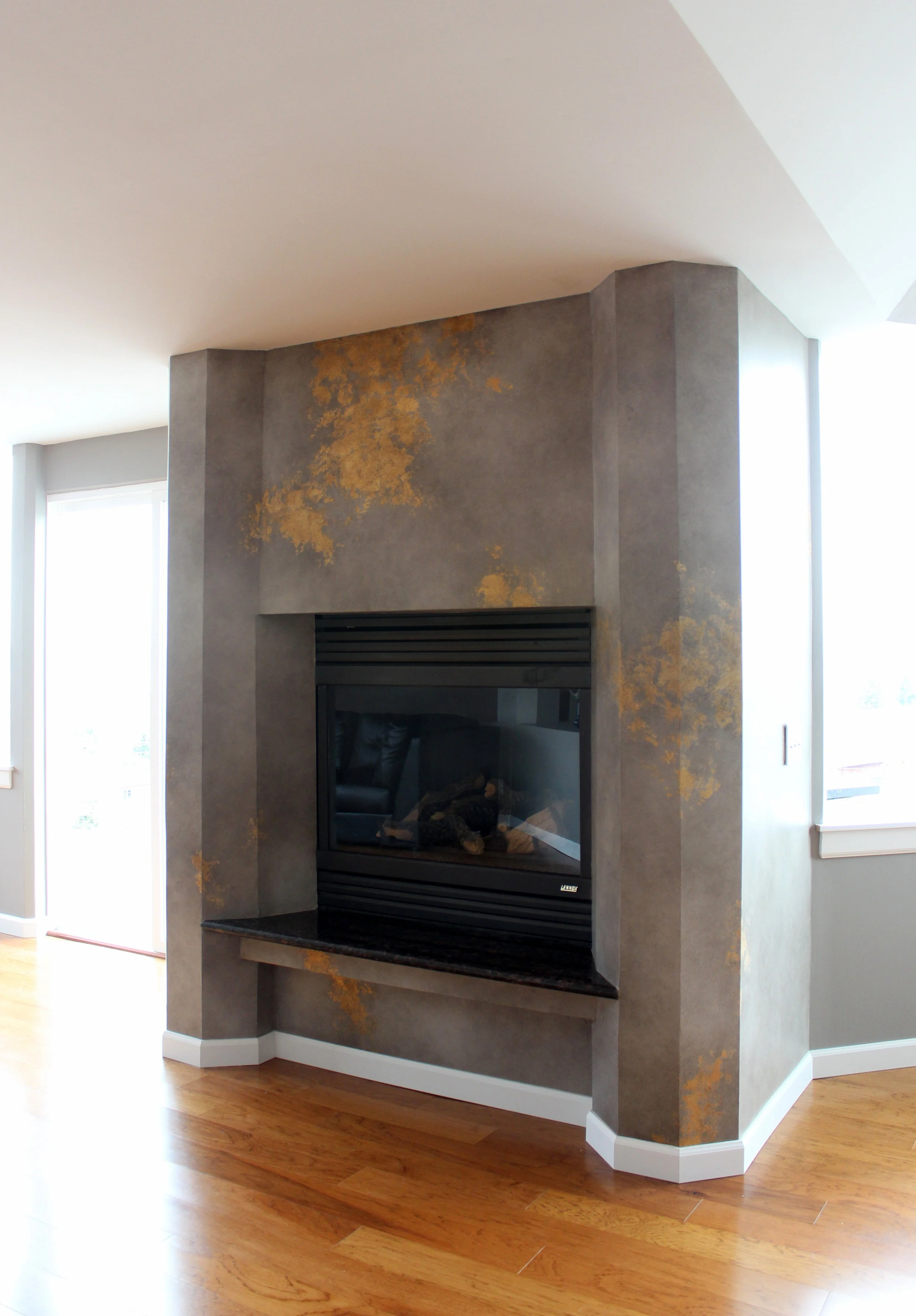 Dutch metal leafed and glazed fireplace surround.