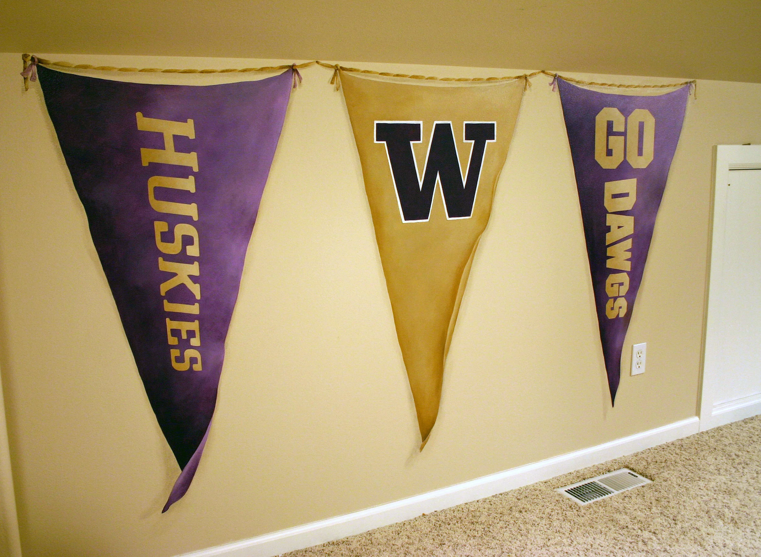 Trompe l' oeil UW banners painted on playroom walls.