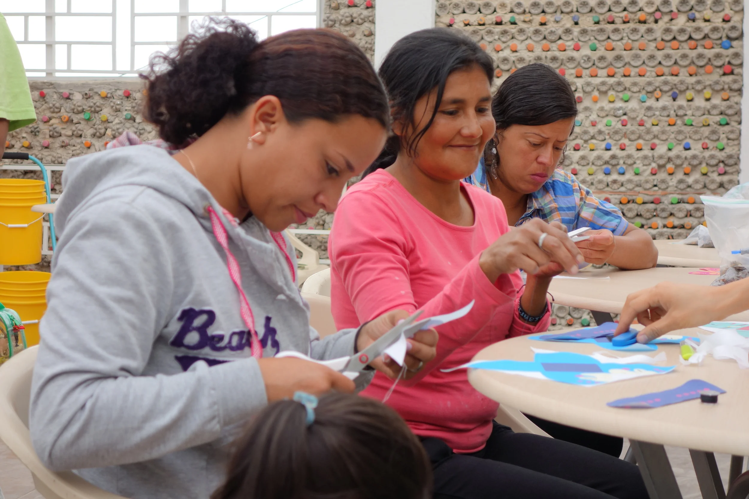 Mireya, Noemi, and Lida learn to sew conejos